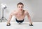 Muscular shirtless sportsman making push-ups in