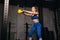 Muscular sportswear throwing kettlebell