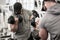 Muscular strong bearded man lifting heavy dumbbells pumping biceps in bodybuilding gym