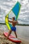 Muscular surfer posing with surfboard.