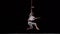 Muscular white circus artist on the aerial straps on black background in slowmotion. Concept of individuality