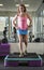 Muscular woman doing step aerobics