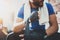 Muscular young boxer with black boxing bandages. Fists of fighter before the fight or training in sport gym. Blurred