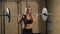 Muscular young fitness beautiful blonde girl lifting a weight cross fit in the gym.