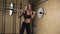 Muscular young fitness beautiful blonde girl lifting a weight cross fit in the gym.