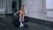 Muscular young fitness beautiful blonde girl lifting a weight cross fit in the gym.