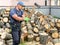 Muscular young man chopping logs