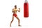 Muscular young man exercising kickboxing with a punching bag