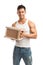 Muscular young man holding parcel