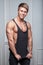 Muscular young man posing in black t-shirt