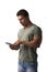 Muscular young man standing reading from e-book device with surprised