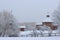 Museum of wooden architecture in Kolomenskoye during snowfall. The tower of the Bratsk fortress and the Gates of the Nikolo-Korels