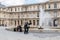 Museum workers and tourists near fountain at Louvre