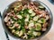 mushroom, cucumber, and green peppers in pot on white counter