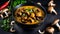 Mushroom curry. Homemade spicy mushroom curry in a black bowl on a dark background.