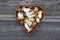 Mushroom fungi boletus in heart form basket on wooden background