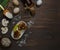 Mushroom julienne in bags of thin wheat pancakes on a dark wooden table with ingredients for cooking