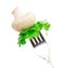 Mushroom and leaves of green salad on a fork Isolated on white b