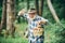 Mushrooming in forest, Grandfather hunting mushrooms over summer forest background.