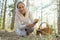 Mushrooming, woman picking mushrooms in the forest