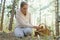 Mushrooming, woman picking mushrooms in the forest