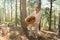 Mushrooming, woman picking mushrooms in the forest