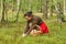 Mushrooming, woman picking mushrooms in the forest