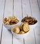 mushrooms and artichokes in oil in ceramic bowl on white wooden background