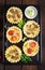 Mushrooms, cheddar, tomatoes tartlets on wooden background.Mushrooms, cheddar, tomatoes tartlets on wooden background.