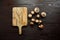 Mushrooms and cutting board, group of fresh brown champignons scattered on a wooden background, top view. Uncooked food ingredient