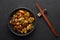 Mushrooms Manchurian dry in black bowl at dark slate background