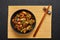 Mushrooms Manchurian dry in black bowl at dark slate background