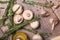 Mushrooms preparation composition. White champignons on a wooden background. Mushrooms with oil, rosemary and garlic.