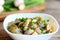 Mushrooms slices in a sour cream sauce. Mushrooms stewed with sour cream and green onions in a bowl. Healthy vegetarian snack