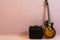 Music background, a amplifier box with a sunburst colored electric guitar