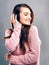 Music brings back great memories. Studio shot of a beautiful young woman listening to music against a gray background.