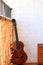 Music Concept: Brown acoustic guitar on a white wall