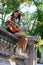 Music Concept: Young and Beautiful woman playing Spanish guitar outdoors in a park