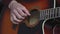 Music, creativity, concert, self-isolation concept. Close-up hands of young man playing an acoustic guitar dreadnought