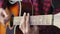 Music, creativity, concert, self-isolation concept. Close-up hands of young man playing an acoustic guitar dreadnought