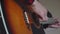 Music, creativity, concert, self-isolation concept. Close-up hands of young man playing an acoustic guitar dreadnought