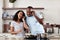 The music gets us going when we cooking. a young married couple listening to music while cooking together in the kitchen