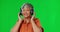 Music, green screen and elderly woman with headphones dance in studio, happy and free on mockup background. Radio