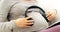 Music helps with the development of the baby. a pregnant woman with headphones over her stomach at home.
