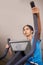 Music helps her focus. a young woman working out in the gym on a stepping machine.