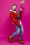 Music Ideas. Expressive Caucasian Female Guitar Player With Yellow Bass Guitar Posing In Fashionable Red Jacket With Lifted