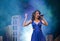 Music and karaoke. beauty and fashion, retro and jazz. live performance, studio, concert, show. singer girl in blue dress with mic