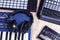 Music making equipment with keyboards, controllers and headphones on wooden background, top view