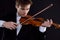 Music, misery, the concept of bad luck. The young violinist is elegantly dressed, shaken, and has a broken bow.