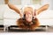 Music is an outburst of the soul. Shot of a young woman listening to music while lying upside down on her couch.